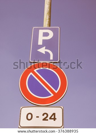  No parking here, cars parking on the left traffic sign over the blue sky vintage