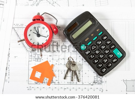 Model house on construction plan for house building, keys , red alarm clock and calculator. Real Estate Concept.