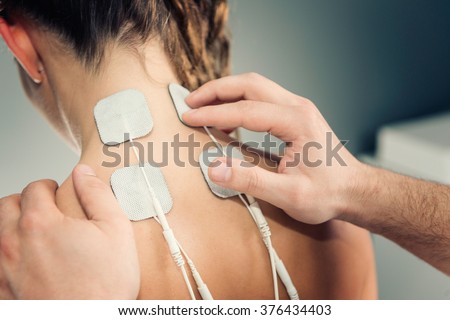 Electro stimulation in physical therapy Royalty-Free Stock Photo #376434403