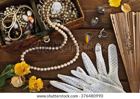 Vintage box with trinkets and jewelry on wooden background Royalty-Free Stock Photo #376480990