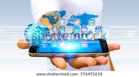 Young man using digital application with icons flying over his mobile phone