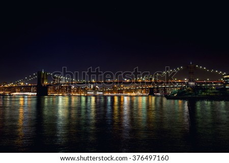 Night Brooklyn Bridge with lights and reflection in water