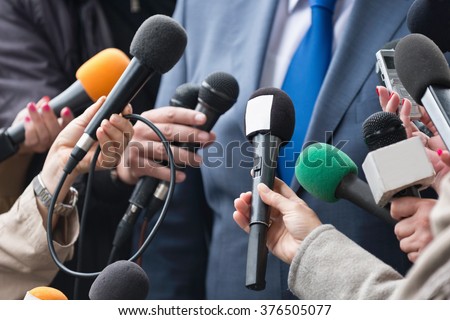 Media interview - group of journalists surrounding VIP Royalty-Free Stock Photo #376505077
