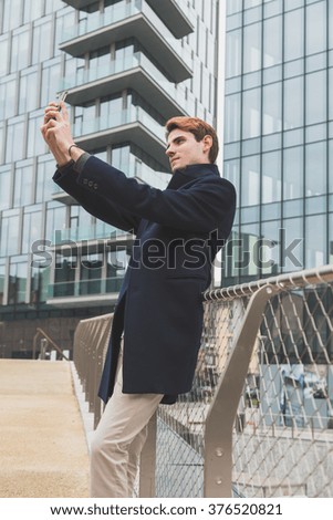 Young handsome man posing in an urban context