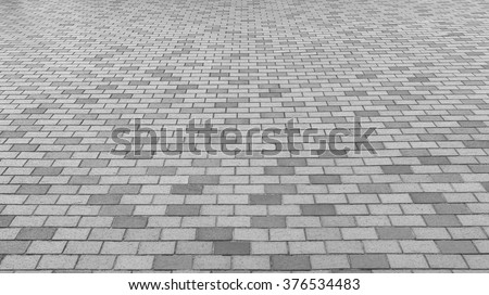Perspective View Monotone Gray Brick Stone Pavement on The Ground for Street Road. Sidewalk, Driveway, Pavers, Pavement in Vintage Design Ground Flooring Square Pattern Texture Background for mock up Royalty-Free Stock Photo #376534483