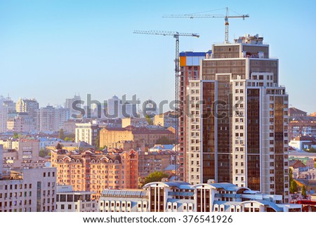 Construction cranes and modern skyscraper in downtown of Kiev, Ukraine