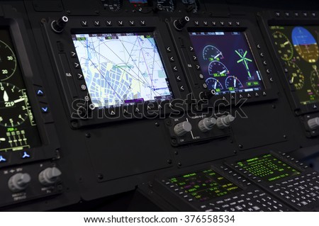 Control panel in military helicopter cockpit, copter dashboard with displays, dials, buttons, switches, faders, knobs, other toggle items, air force, modern aviation and aerospace industry  Royalty-Free Stock Photo #376558534