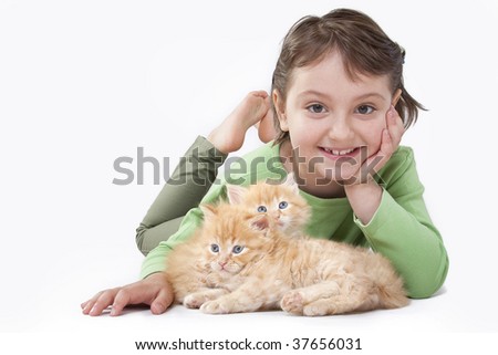 A cute little girl playing with baby cat