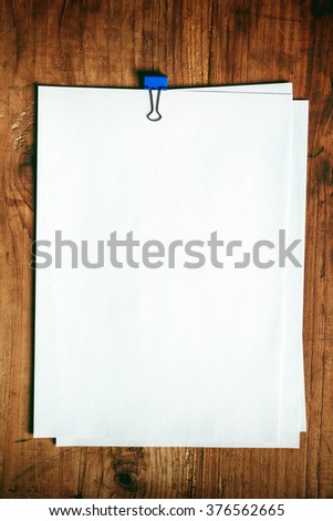 Blank A4 white paper on office desk, top view as mock up copy space for business report or plan.