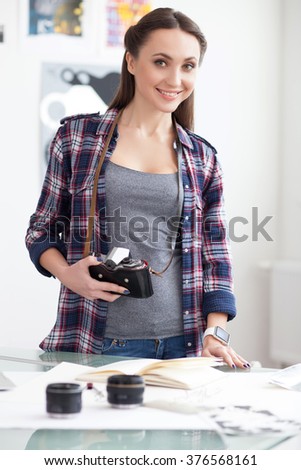 Attractive young photographer is expressing positive emotions