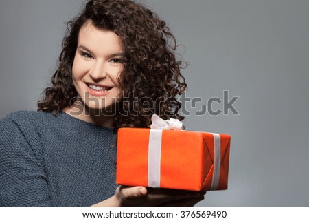 Cute young girl is carrying a gift