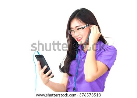 girl listening to the music with headphones on smart phone