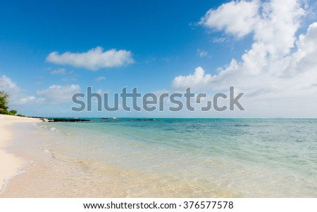 Sunny picture of tropical beach with transparent water on the east coast of Mauritius Island. Beautiful view of the lagoon of a tropical island in the Indian ocean