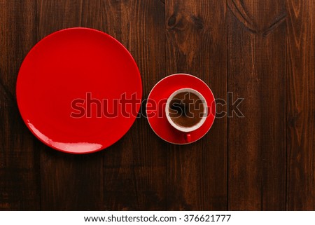 Top view of coffee in red cup on wooden vintage table. top view