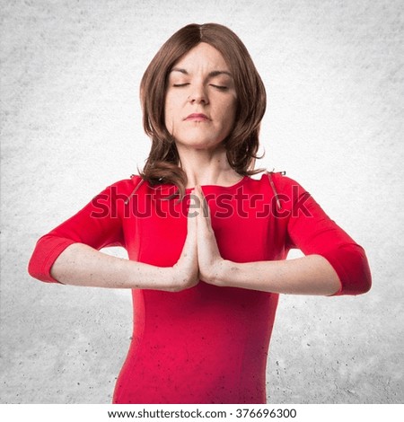 Brunette woman in zen position over textured background