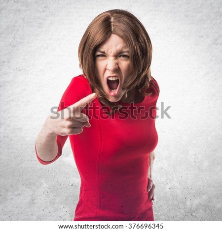 Brunette woman shouting over textured background