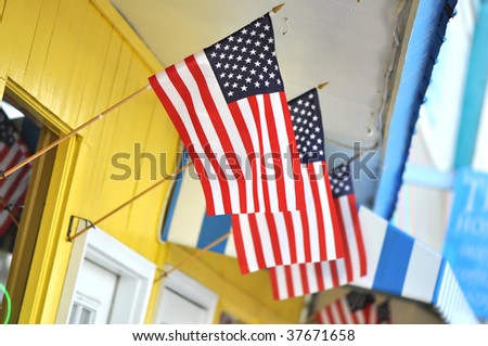 Colorful store front with three American flags flying.