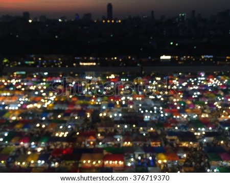 Blurred bokeh aerial view multiple colour weekend market roof top