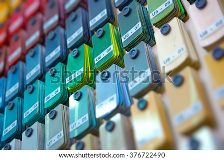 Stand of paint samples choosing color for painting car, closeup. Choosing the right color before car paint. Customer choosing color background. Opportunity choose a color before painting the car Royalty-Free Stock Photo #376722490