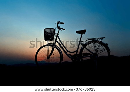 Silhouette of bicycle with  sunset at SINGHA PARK CHIANG RAI , Chiang rai province, Thailand.