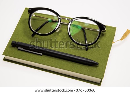 Glasses  and Pen on a Book