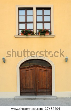 old house entrance door, vertical photo, flower-pot in window
