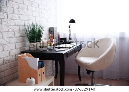 Workplace with laptop on table at home Royalty-Free Stock Photo #376829140