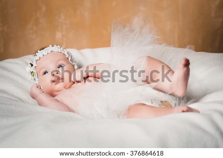 Little baby girl in tutu with angel wings