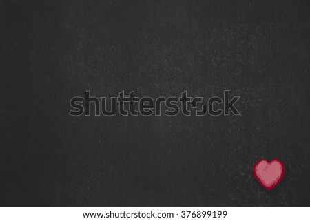 Red little heart in the corner at dark background