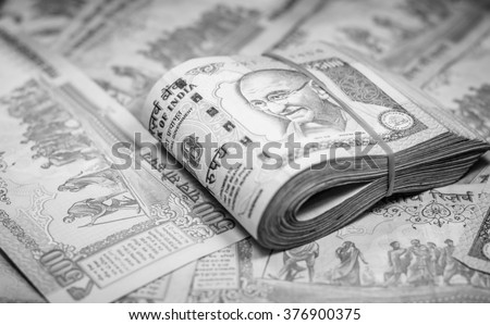 Success and got profit from business with 500 banknotes of indian rupee currency,money on black and white color,Focus on eye of Gandhi Royalty-Free Stock Photo #376900375