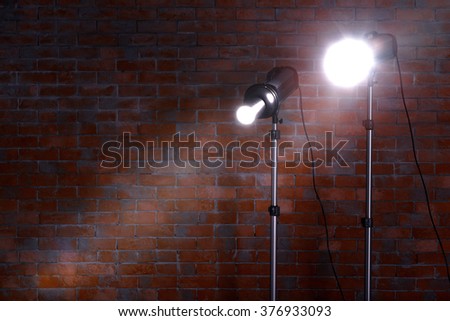Studio light flashes on brick wall background