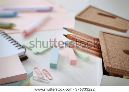 Notebook with stationery on a white table