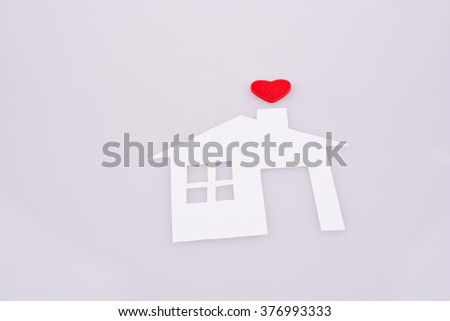 White paper house with a small red heart
