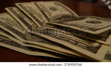 One hundred dollar banknotes funned out on table at the office stock photo