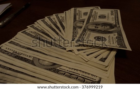 Stack of one hundred 100 dollar bills funned out on table at bank stock photos