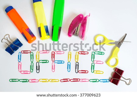 colored clips and office supplies isolated on white