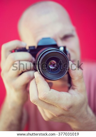 Young man closeup portrait with camera