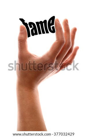 Color vertical shot of a hand squeezing the word "fame".