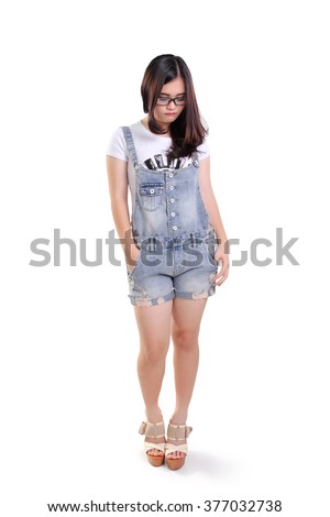 Full length portrait of cute sad nerdy girl looking down, isolated on white background