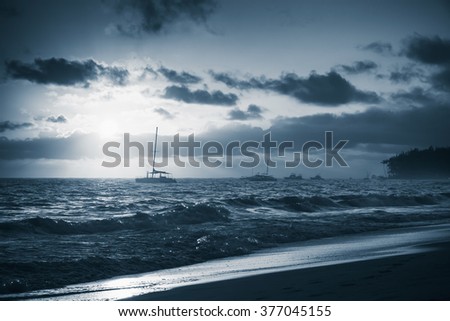 Colorful sunrise over Atlantic ocean. Dominican republic, Punta Cana beach. Blue toned monochrome photo filter effect