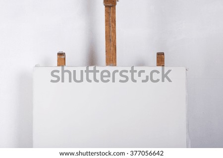 A white canvas on an easel