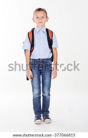 Serious school boy with bag isolated on white background