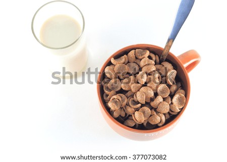 Big brown ceramic cup full of chocolate cereal. Surf with milk