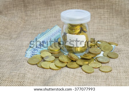 Gold coins in bottle  with word school,Saving concepts