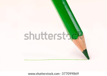 green pencil with line over white background