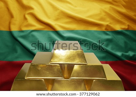shining golden bullions on the lithuanian flag background