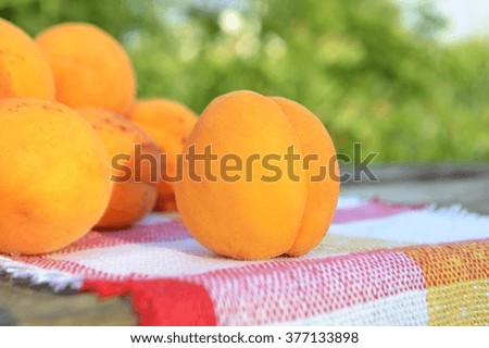 Organic apricots on wooden background.