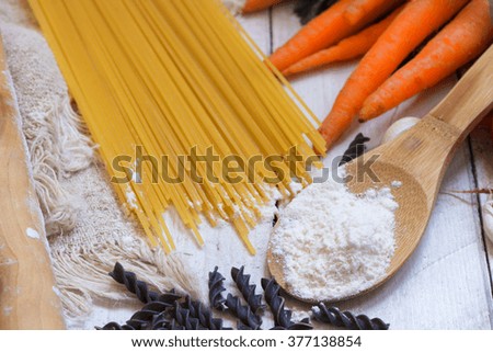 Ingredients for pasta: spaghetti, vegetables and spices on the old table. top view