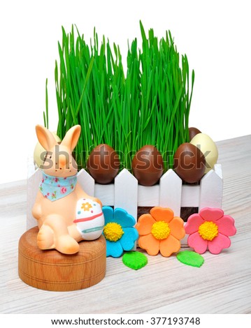 Easter bunny, easter eggs and green grass decoration isolated on white