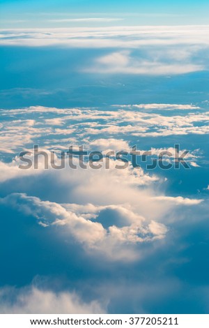 Above The Clouds. This picture was taken out of an airplane and shows the beautiful cloudscape in the evening light.